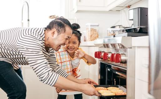 A father and daughter baking cookies